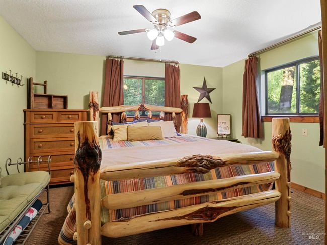 Carpeted bedroom featuring ceiling fan and a textured ceiling | Image 4