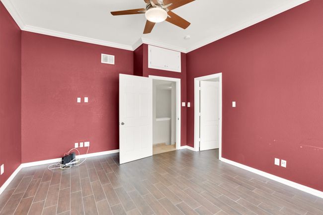 Spare room featuring visible vents, crown molding, baseboards, and ceiling fan | Image 20