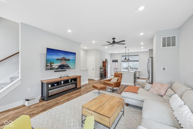 living area with visible vents, stairs, ceiling fan, recessed lighting, and light wood-style floors | Image 4