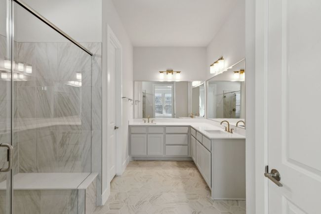 Full bath with double vanity and a marble finish shower | Image 20