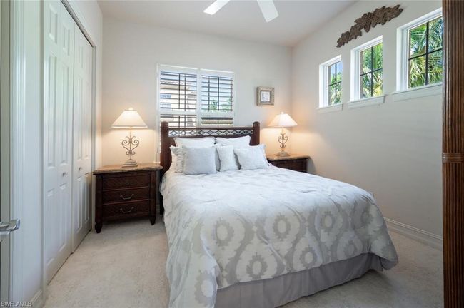 A wall of closets & well placed windows in bedroom #2 | Image 36