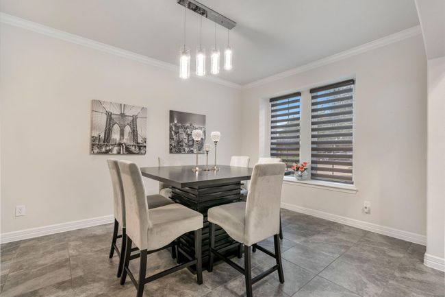 Large windows allow for natural light, while neutral tones and contemporary feel create a sophisticated atmosphere. | Image 5