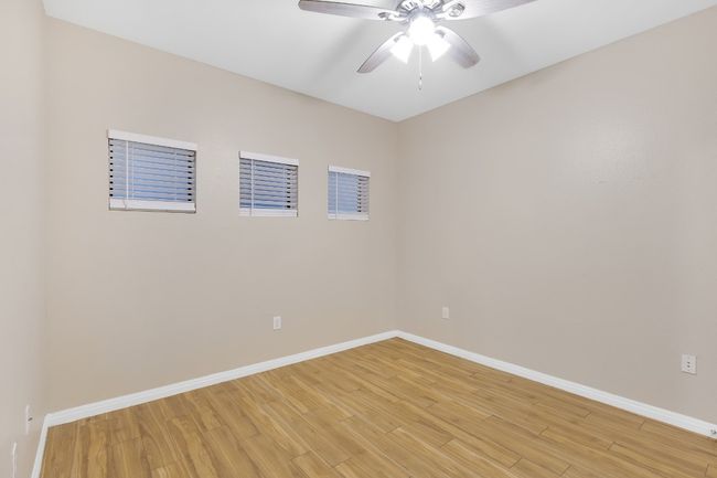 2nd bedroom featuring baseboards, new ceiling fan, and light wood-style floors. All new blinds too. | Image 15