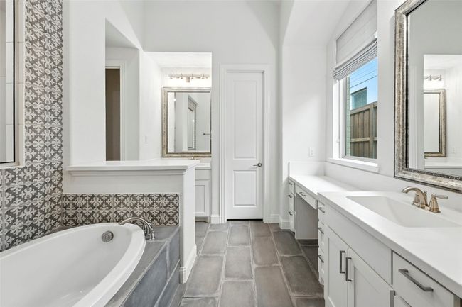 Bathroom with vanity, a garden tub, and tile patterned floors | Image 20