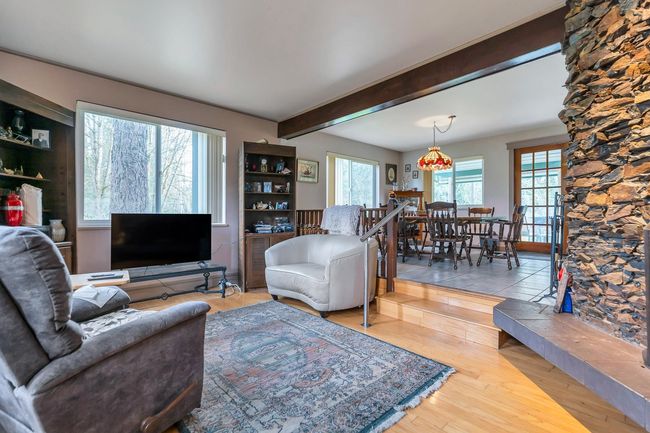 Living area with beamed ceiling and wood finished floors | Image 17