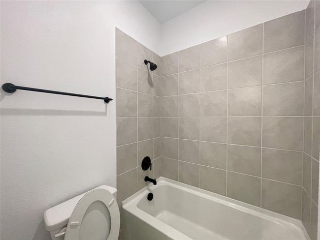 Bathroom featuring toilet and shower / washtub combination | Image 26