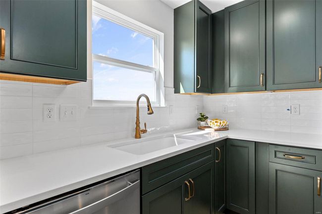 Kitchen with green cabinetry, dishwasher, tasteful backsplash, and sink | Image 14