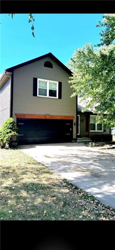 View of front property with a garage and a front yard | Image 1