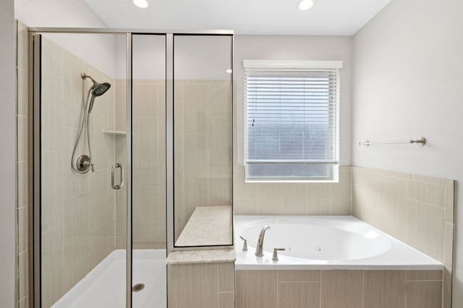 Full bathroom featuring a shower stall and a bath | Image 23
