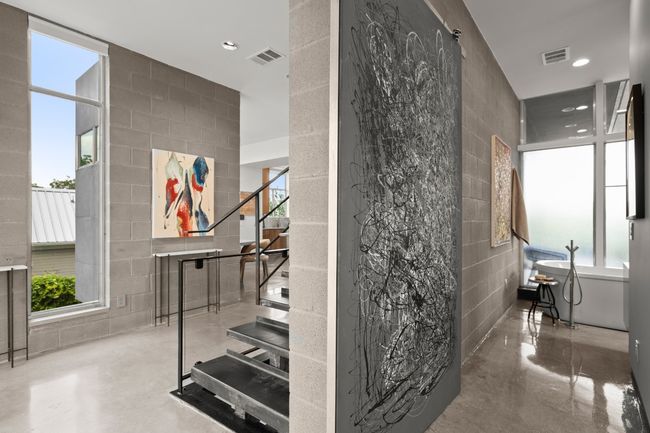 Stairway featuring tile walls, finished concrete flooring, healthy amount of natural light, and recessed lighting | Image 8