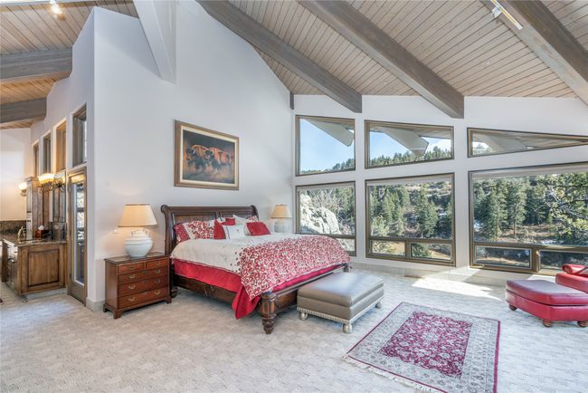 Bedroom with high vaulted ceiling, wood ceiling, light carpet, and beamed ceiling | Image 18