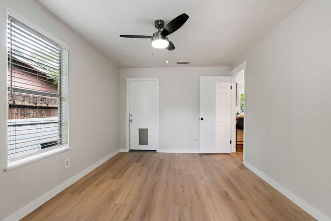 This angle displays the bedroom's entryway and the door leading to the backyard. | Image 15