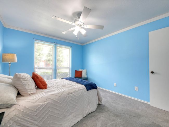 Bedroom with crown molding, carpetk flooring, and ceiling fan | Image 23