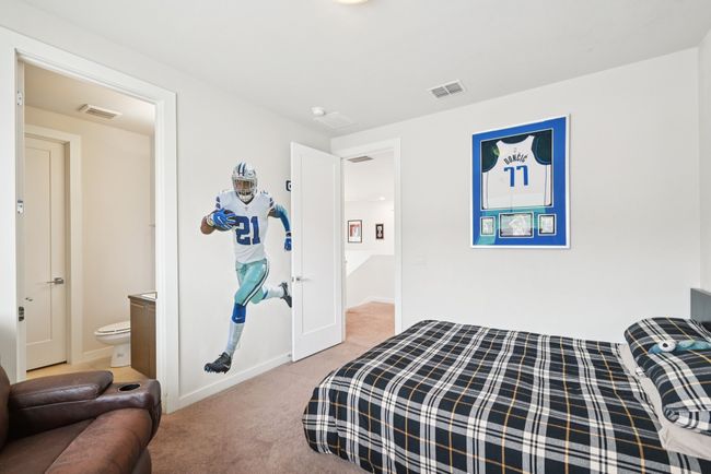 Carpeted bedroom with baseboards and ensuite bathroom | Image 19