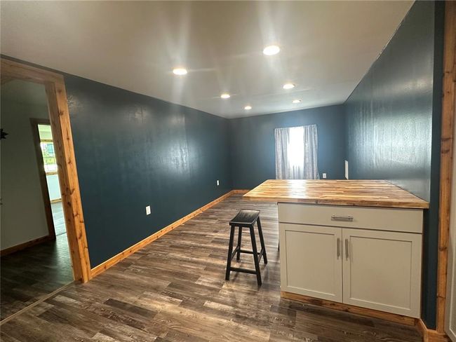 Empty room with baseboards and dark wood finished floors | Image 4