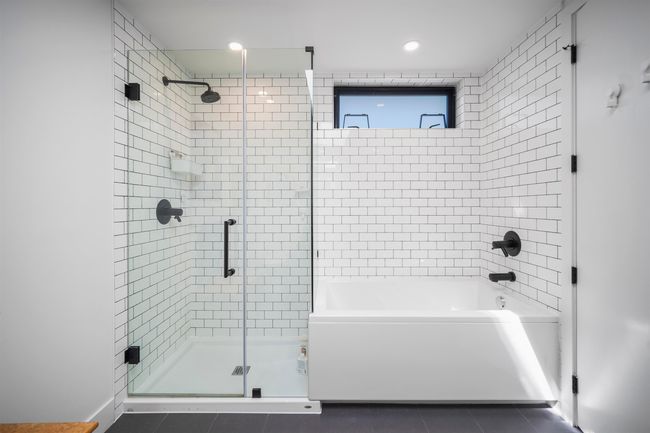 Bathroom with a stall shower, tile patterned flooring, a bathtub, and recessed lighting | Image 16