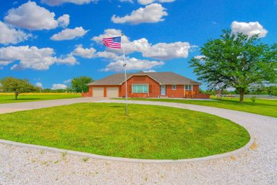 Single story home with a garage and a front lawn | Image 1