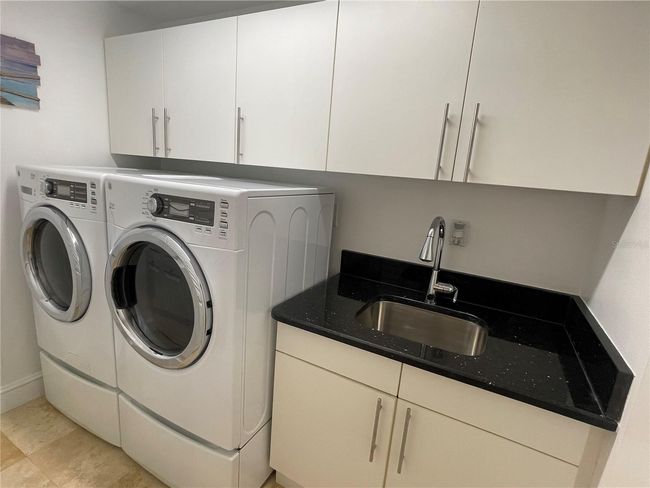En-suite extra large capacity washer/dryer as well as granite counter top and stainless sinl | Image 33