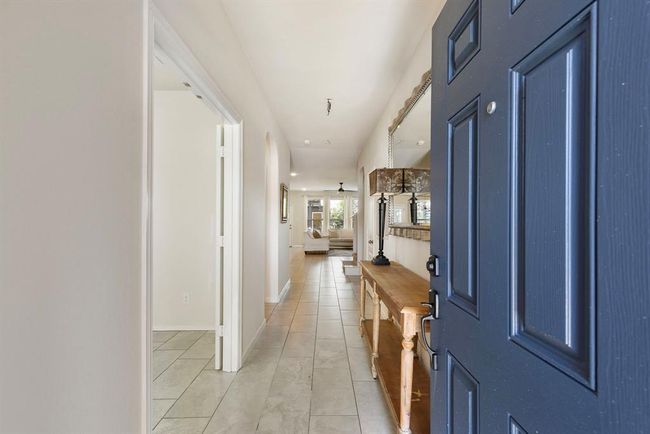 You are greeted by the freshly painted front door & beautifully tiled floor. | Image 5