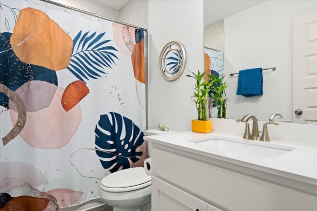 Full bath featuring vanity, a shower with shower curtain, and toilet | Image 25