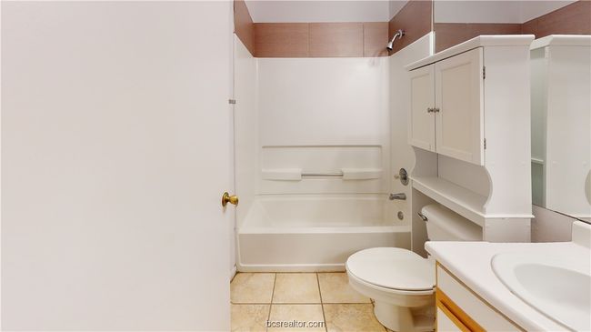 Full bathroom featuring toilet, vanity, shower / bathing tub combination, and tile patterned floors | Image 22