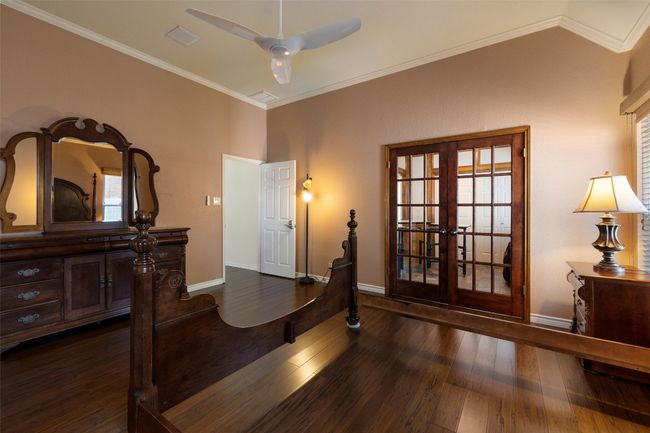 Entryway with french doors, dark wood finished floors, baseboards, ornamental molding, and lofted ceiling | Image 22