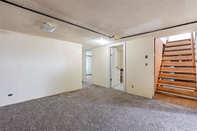 Spacious lower-level room for entertainment or storage. | Image 49