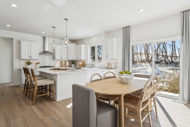 Photo is of the actual model. Soaked in natural sunlight, the homes eat-in dining room has ample space for a dining table located in the heart of the home. | Image 7