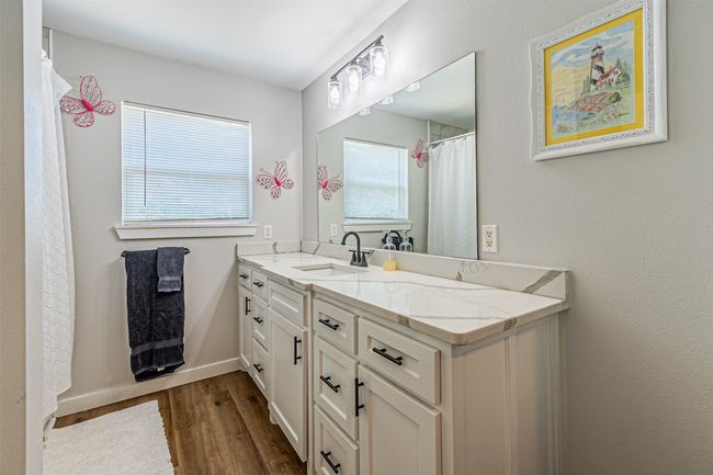 Full bath featuring wood finished floors and vanity | Image 25
