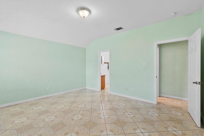 Unfurnished room with lofted ceiling, baseboards, and light tile patterned floors | Image 14