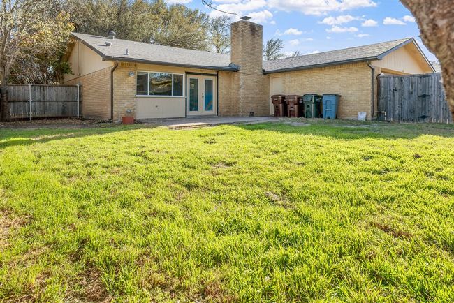 Back of house featuring brick siding, french doors, and a yard | Image 38