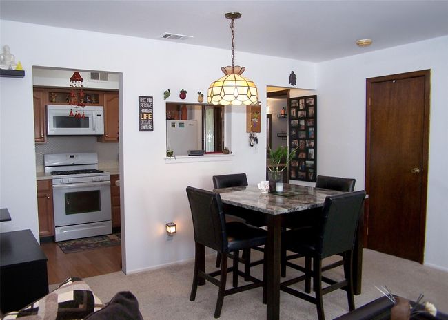 Dining space with carpet and baseboards | Image 5