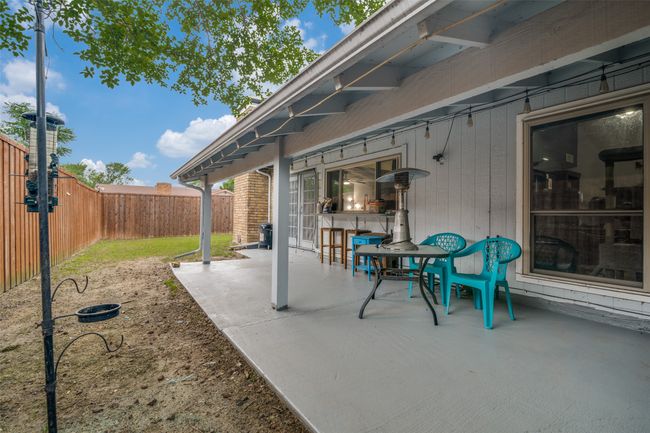 Fenced backyard with a patio | Image 23