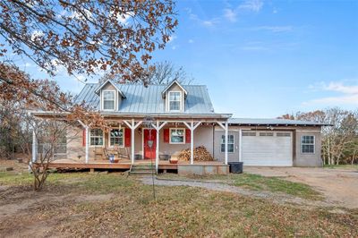 View of front of property with a garage and covered porch | Image 1