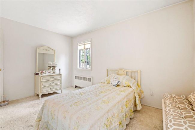 Carpeted bedroom with radiator heating unit | Image 17