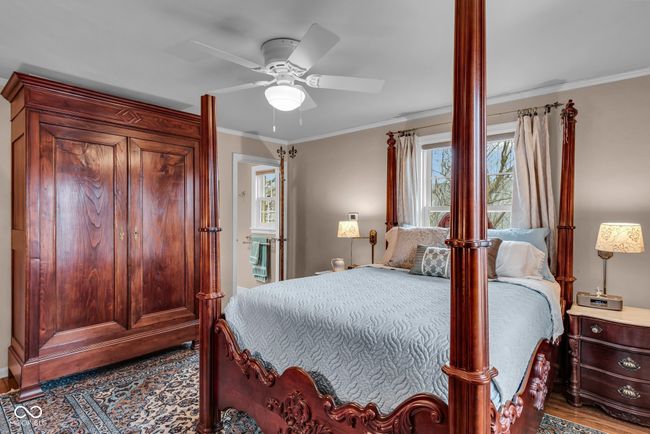 bedroom featuring crown molding, wood finished floors, and a ceiling fan | Image 17