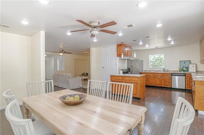 Dining area with sink, ceiling fan, and dark hardwood / wood-style floors | Image 21