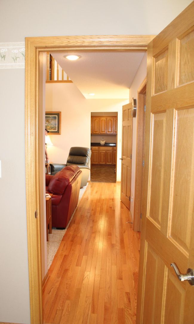 View from primary bedroom out to living room and kitchen area. | Image 54
