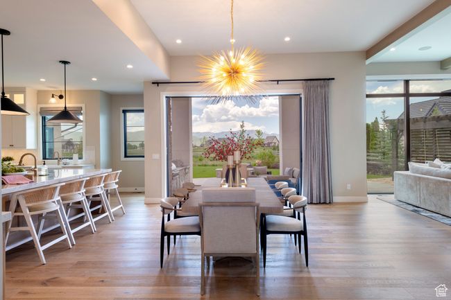Dining area with light wood-style floors, a chandelier, and recessed lighting | Image 10