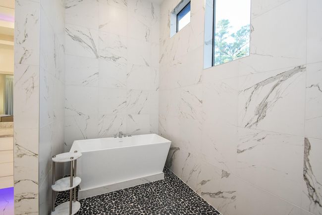 Elegant soaking tub in the huge walk-in shower, plus windows for natural light. | Image 27