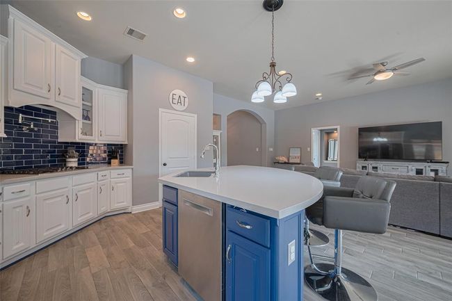 Ample countertop space provides plenty of room for meal prep, while generous cabinet storage keeps all your kitchen essentials organized and within reach. Undercabinet lighting illuminates the space. | Image 18
