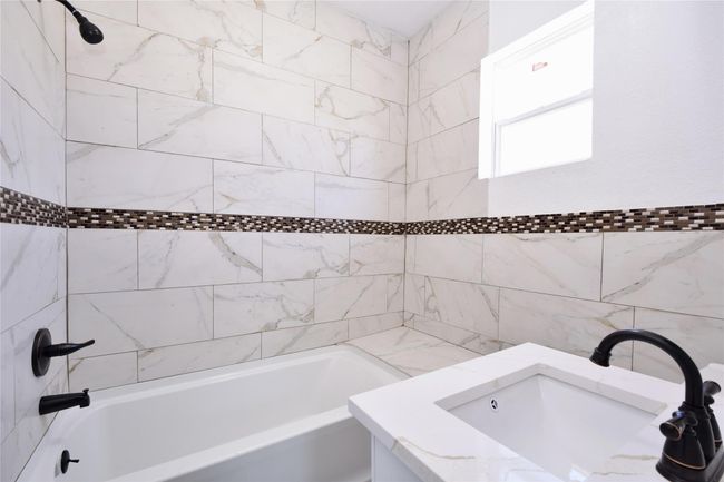 Full bath featuring shower combination and vanity | Image 7
