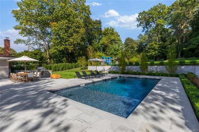 View of swimming pool with a patio | Image 2