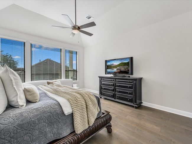 Bedroom with wood finished floors and ceiling fan | Image 23
