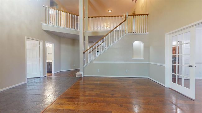 Inviting family room with elegant double doors opening to the dining area. | Image 5