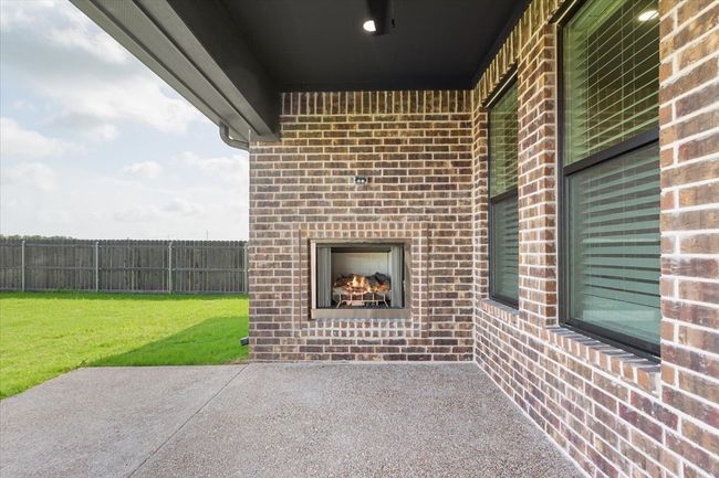 View of patio with a lit fireplace | Image 34