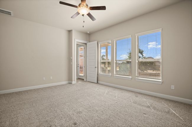 Empty room featuring ceiling fan, light carpet, baseboards, and visible vents | Image 18