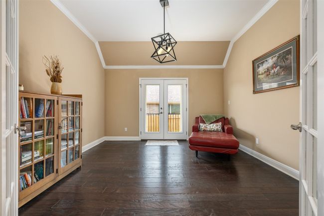 Living area with french doors, vaulted ceiling, dark wood-style flooring, and ornamental molding | Image 12