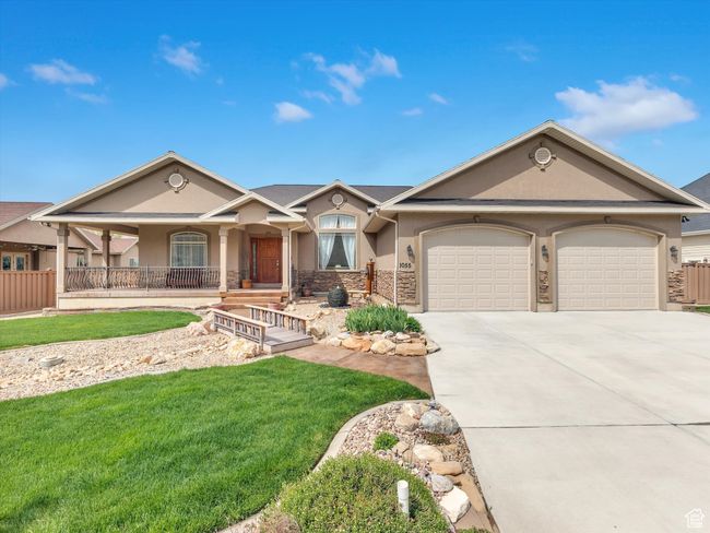 Ranch-style home featuring a front lawn, driveway, covered porch, a garage, and stucco siding | Image 40