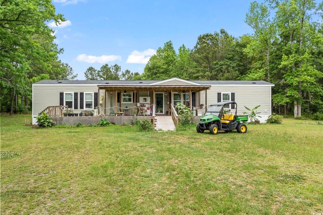 Rear view of house featuring a yard and a porch | Image 35
